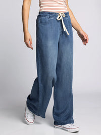 Side view of Thread & Supply Austin Pants showing relaxed wide-leg design and lightweight denim material for casual comfort.